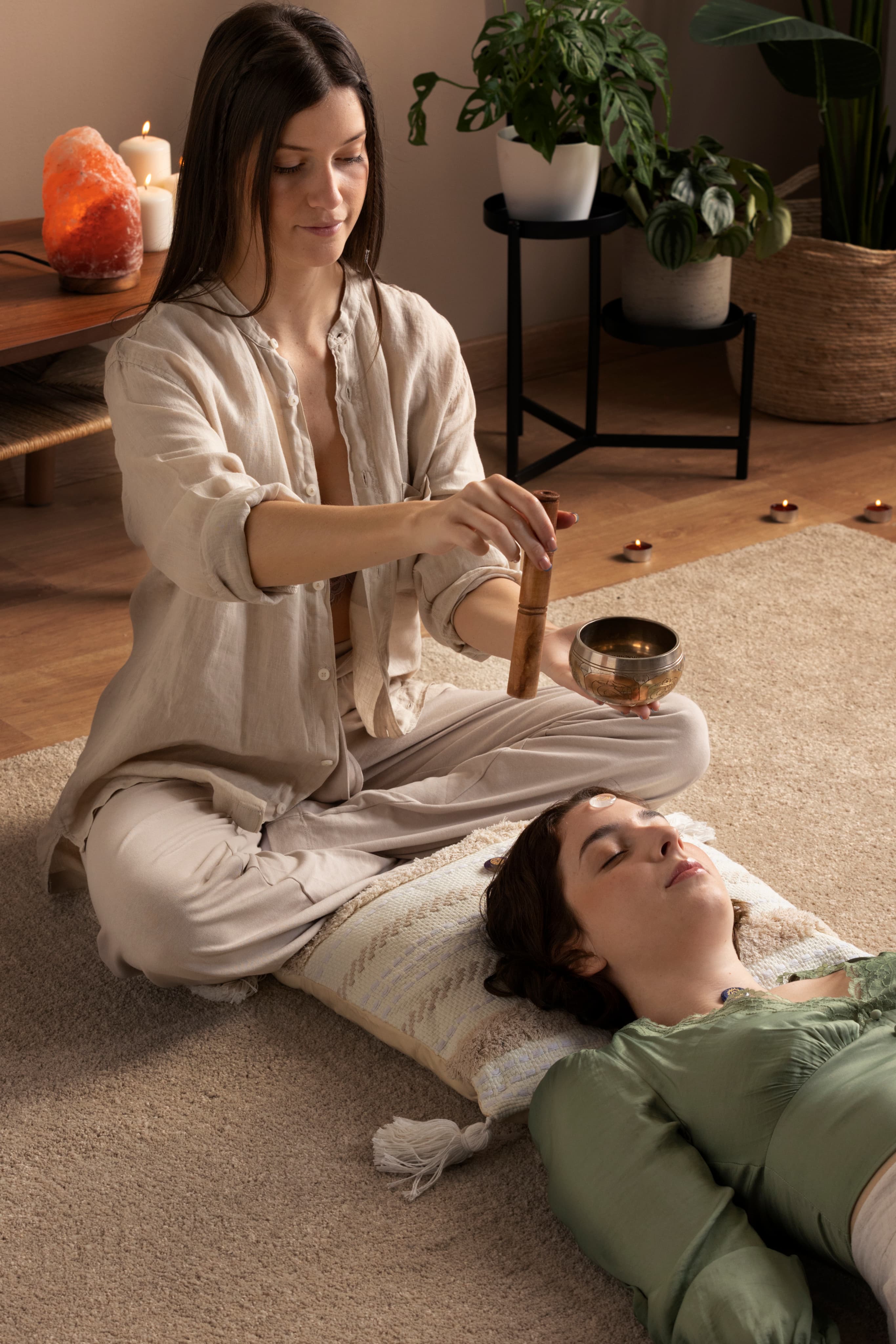 Ayurvedic therapist performing a calming Kaya Chikitsa consultation for a resting patient.